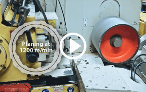Close-up of a Gilbert industrial planer in operation, planing wood at a speed of 1200 meters per minute.