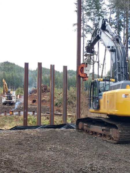 The Gilbert Grizzly MultiGrip installed H-beams with a MG-90 pile driver for a logging road bridge in Western USA. 